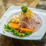 vegetable salad on white plate on brown table
